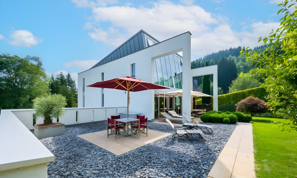 Terrasse mit Sonnenschirm vor moderner Villa | Terrace with sun umbrella in front of modern villa
