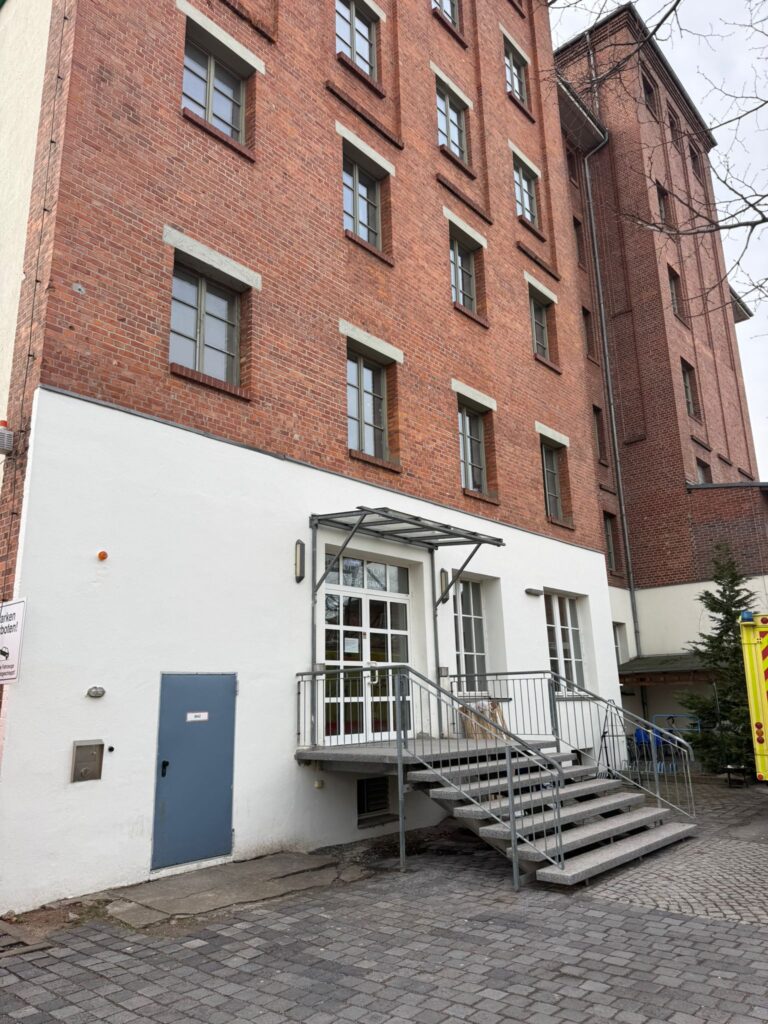 Backsteingebäude mit Eingangstreppe und Vordach | Brick building with entrance staircase and canopy